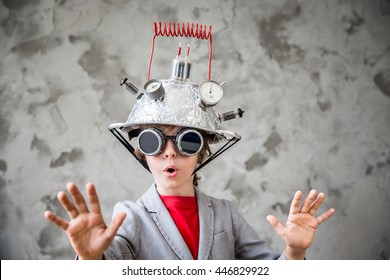Portrait of young child pretend to be businessman. Kid with toy virtual reality headset in modern loft office. Success, creative and innovation VR technology concept. Copy space for your text