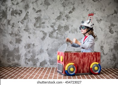 Portrait Of Young Child Pretend To Be Businessman. Kid With Toy Virtual Reality Headset In Modern Loft Office. Success, Creative And Innovation Technology Concept. Copy Space For Your Text