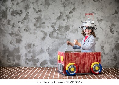 Portrait Of Young Child Pretend To Be Businessman. Kid With Toy Virtual Reality Headset In Modern Loft Office. Success, Creative And Innovation Technology Concept. Copy Space For Your Text