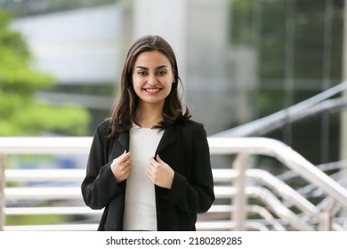 Portrait of young confident Indian Business woman smile and look at camera at outdoor. - Powered by Shutterstock