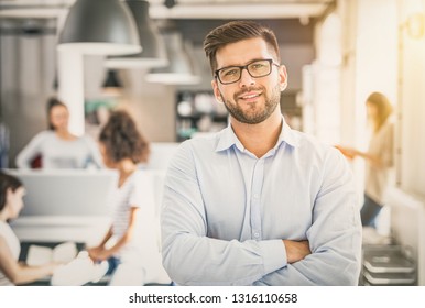 Portrait Of Young Confident Man Leader Standing In Office. New Start Up Business Concept.