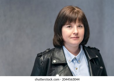 Portrait Of Young Confident Woman With Bob Haircut In Leather Jacket. Brunette Girl With Round Face Shape. Middle Aged Woman