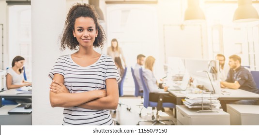 Portrait Of Young Confident Woman Leader Standing In Office. New Start Up Business Concept.