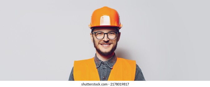 Portrait Of Young Construction Worker On White Background. Panoramic Banner.