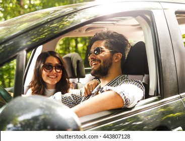 Portrait Of Young Couple Driving A Car.