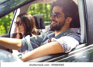 Portrait Of Young Couple Driving A Car.