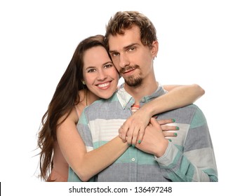 Portrait of young couple embracing isolated over white background