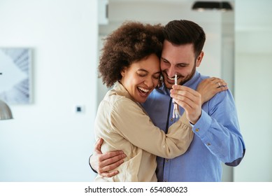 Portrait of young couple feeling happy about buying a new house.