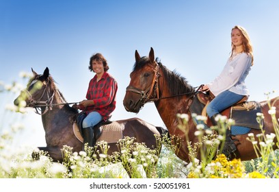 Portrait Of Young Couple Horseback Riding