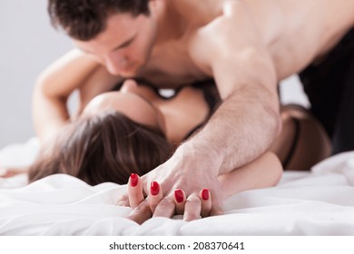 Portrait of young couple making love in bed