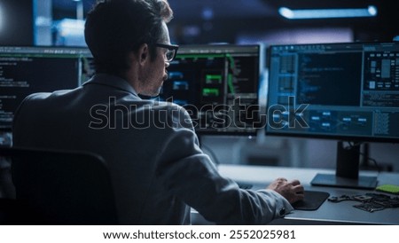 Portrait of Young Creative Manager Using Desktop Computer, Writing Code for an Innovative Technological Internet Product Launch. Enthusiastic Professional Developer Working in Modern Office