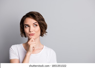 Portrait of young curious thoughtful beautiful girl woman female look in copyspace hold hand on chin isolated on grey color background - Shutterstock ID 1851351322