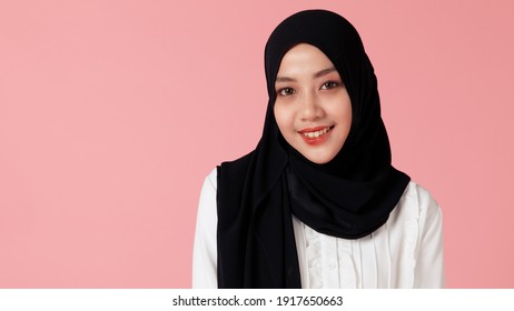 Portrait of young and cute Asian Islamic woman pose to camera with smile and happy face.