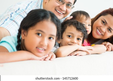 Portrait of a young cute boy posing with his family on the foreground
