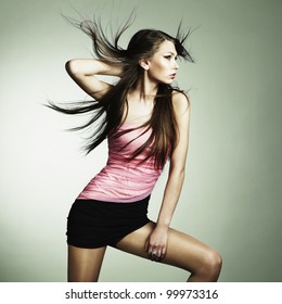 Portrait Of Young Dancing Woman With Long Flowing Hair. Fashion Photo