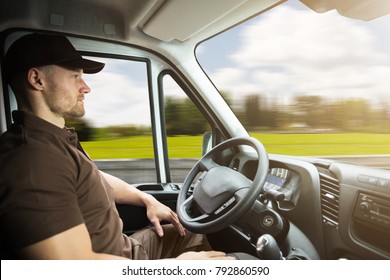 Portrait Of A Young Delivery Man Sitting Inside Self Driving Van