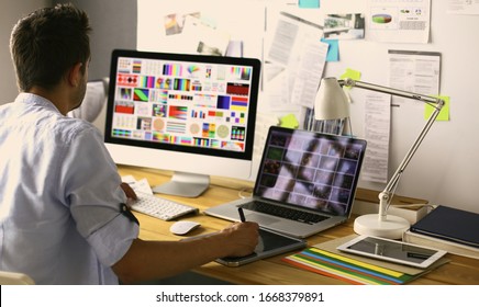 Portrait Of Young Designer Sitting At Graphic Studio In Front Of Laptop And Computer While Working Online.