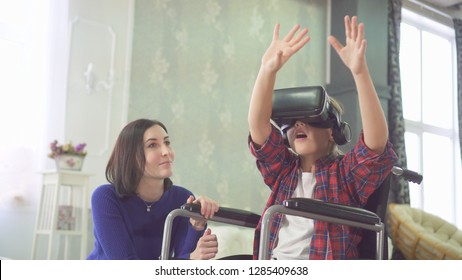 Portrait Young Disabled Woman In A Wheelchair, Uses Vr Helmet, 3D Technology