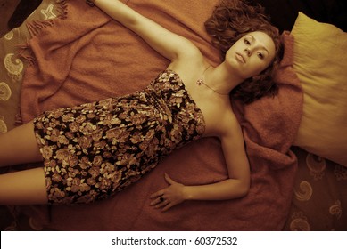 Portrait of young disappointed woman in bed