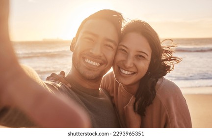 Portrait of a young diverse biracial couple taking a selfie at the beach and having fun outside. Portrait of a young diverse biracial couple taking a selfie at the beach and having fun outside. - Powered by Shutterstock