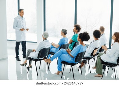 Portrait of a young doctor teaching on a seminar in a board room or during an educational class at convention center  - Powered by Shutterstock