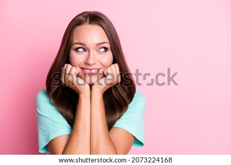 Portrait of young dreamy smiling positive good mood woman look copyspace hold hands chin isolated on pink color background