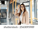 Portrait of young elegant woman riding a public transportation and commuting.