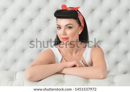 Portrait of a young emotional woman posing. Pin-up style