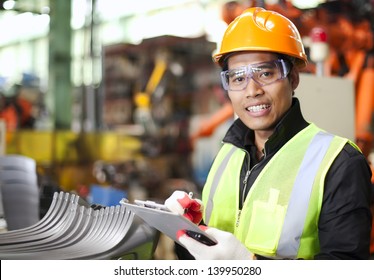 Portrait Of Young Engineer Taking Notes