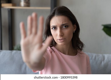 Portrait of young ethnic woman show hand palm stop gesture sign protest against gender or racial discrimination, unhappy determined indian Arabic female say no to inequality, domestic violence