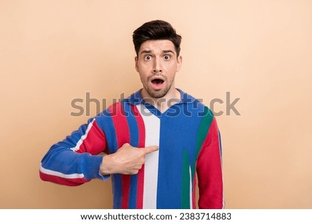 Portrait of young excited funny grimace man wear shirt businessman pointing finger himself shocked isolated on beige color background