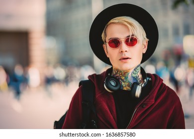 A portrait of a young fair-haired guy walking in the street. Beauty, optics, casual fashion. - Shutterstock ID 1636857580