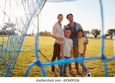 Portrait Of A Young Family During A Football Game