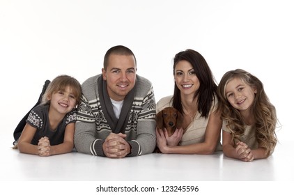 Portrait of young family on white background.