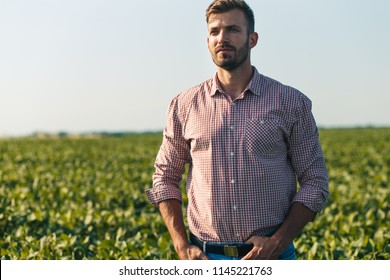 Portrait Of Young Farmer In Soybean Filed.