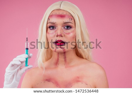 portrait young fashion victim blonde Barbie woman perfect halloween make up face draw line and big red lips with silicone breast implants.plastic surgery addiction afraid to be yourself concept