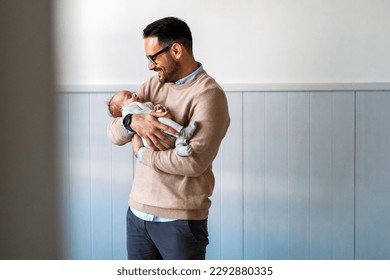 Portrait of young father holding his newborn baby. Fatherhood love single dad fathers day concept. - Shutterstock ID 2292880335