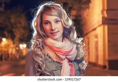 Portrait Of A Young Female Businesswoman In Night City. Close-up, Shallow DOF. Headshot Of 25 Year Old Female In Night Megapolis. Copy Space. Backlit Image. Vintage Color.