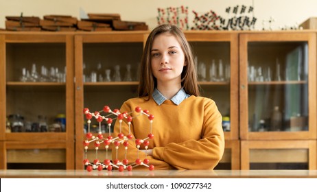 Portrait of young female college student in chemistry class. Focused student in classroom. Authentic Education concept. - Powered by Shutterstock