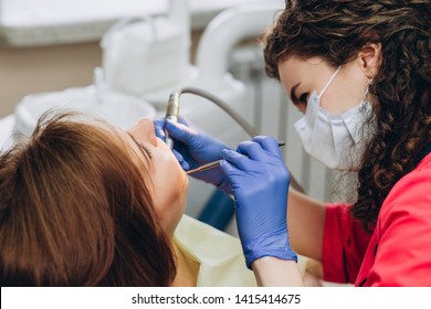 Portrait Of Young Female Dentist In Office. Dentist With Tools. Woman Undergo Dental Check Up. Social Medicine, Budget Dental Clinic In Poor Countries