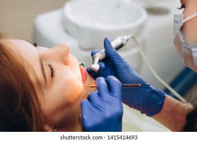 Portrait Of Young Female Dentist In Office. Dentist With Tools. Woman Undergo Dental Check Up. Social Medicine, Budget Dental Clinic In Poor Countries