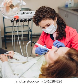 Portrait Of Young Female Dentist In Office. Dentist With Tools. Woman Undergo Dental Check Up. Social Medicine, Budget Dental Clinic In Poor Countries