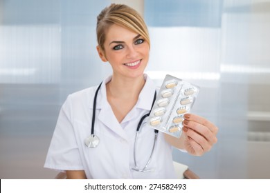 Portrait Of Young Female Doctor Holding Medicine