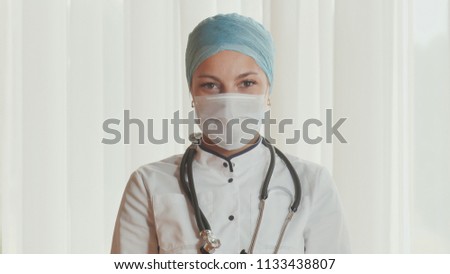 Portrait of a young female doctor in a mask.