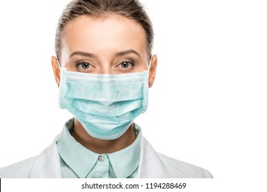 Portrait Of Young Female Doctor In Medical Mask Looking At Camera Isolated On White