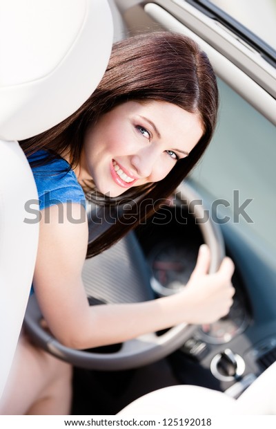 Portrait of young\
female driver turning\
back