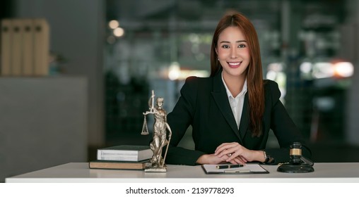 Portrait of young female Lawyer or attorney working in the office, smiling and looking at camera. - Shutterstock ID 2139778293