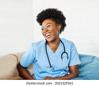 Portrait Of A Young Female Nurse Caregiver In A Nursing Home Or Visit In Household