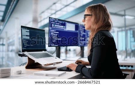 Portrait Of A Young Female Programmer Coding Security Software On Laptop. A Female Engineer Using Agile Methodology