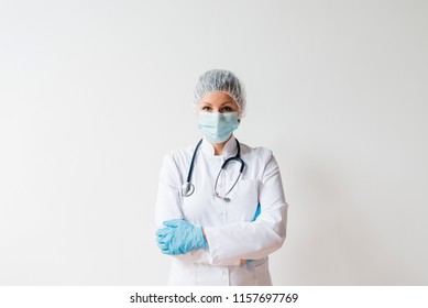 Portrait Of A Young Female Scientist Or Surgeon In White Uniform On Isolated Background.